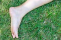 bare feet and hands with creative teens manicure and pedicure on the green grass lawn background Royalty Free Stock Photo