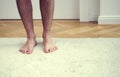 Bare feet of man standing on white carpet Royalty Free Stock Photo