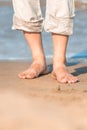 Bare feet in the men's linen trousers Royalty Free Stock Photo