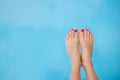 Bare feet over blue swimming pool water Royalty Free Stock Photo