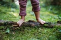 Bare feet of small child standing barefoot outdoors in nature, grounding concept. Royalty Free Stock Photo