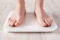 Bare feet stand on smart scales that makes bioelectric impedance analysis, BIA, body fat measurement. Royalty Free Stock Photo