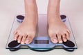 Bare feet standing on a weight scales Royalty Free Stock Photo