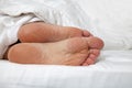 Bare feet under duvet Royalty Free Stock Photo