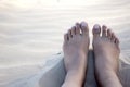 Bare feet on warm white sand.