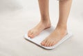 Bare feet on weight scale, overweight control, obese problem, lost weight concept