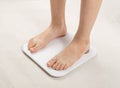 Bare feet on weight scale, overweight control, obese problem, lost weight concept