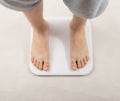 Bare feet on weight scale, overweight control, obese problem, lost weight concept