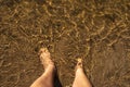 Bare feet of woman with sand bottom in a river Royalty Free Stock Photo