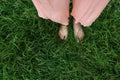 Bare feet of woman standing in lush green grass Royalty Free Stock Photo