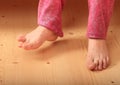 Bare feet on wooden floor
