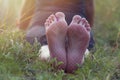 Bare feet on yoga with hobnail. Legs after meditation and spiritual practice lie on the grass in nature. Close-up. The Royalty Free Stock Photo