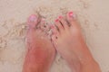Bare feet of a young couple in wet sand Royalty Free Stock Photo