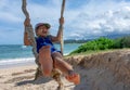 Bare Foot Girl Swings on a Rope Swing by the Beach Royalty Free Stock Photo