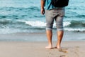 Bare footed man standing on the beach
