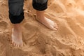 Bare male feet on the sand