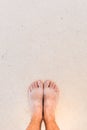 Bare male feet standing on the concrete surface, top view with copy space
