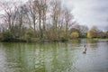 Bare trees to back ground, lake foreground