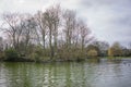 Bare trees to back ground, lake foreground