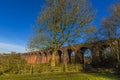 Bare trees and the Victorian railway viaduct at John O`Gaunt valley, Leicestershire, UK