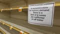 Carlsbad, CA / USA - March 13, 2020: Bare water shelves in a grocery store, and a sign limiting purchases.