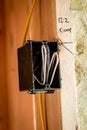 Close up of a black plastic electrical box mounted to the wall with wires exposed Royalty Free Stock Photo