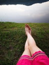 Bare Woman is Feet on The Green Grass. Copy Space. Woman Legs and Feet on Green Grass Near River Royalty Free Stock Photo