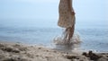 Bare woman feet jumping in ocean water close up. Girl have fun bouncing on waves Royalty Free Stock Photo