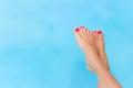 Bare woman feet over blue swimming pool water Royalty Free Stock Photo