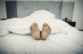 Bare woman`s feet in bedroom. Royalty Free Stock Photo