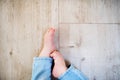 A baby feet of an unrecognizable boy sitting on the floor at home. Copy space. Royalty Free Stock Photo