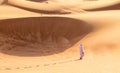 Barefoot Bedouin Walking in Desert of Sharjah