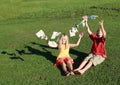 Barefoot boy and girl throwing money