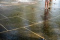 Small child plays in an urban public fountain water park Royalty Free Stock Photo