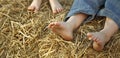 Barefoot children`s feet in the hay Royalty Free Stock Photo