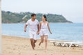 Barefoot couple on sand seashore in cloudy day Royalty Free Stock Photo