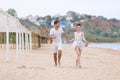 Barefoot couple on sand seashore in cloudy day Royalty Free Stock Photo