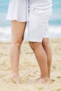 Barefoot couple on sand seashore in cloudy day Royalty Free Stock Photo