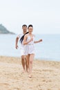 Barefoot couple on sand seashore in cloudy day Royalty Free Stock Photo