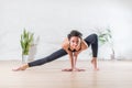 Barefoot elegant Caucasian ballerina doing stretching exercise standing on tiptoe in side lunge position looking at Royalty Free Stock Photo