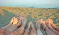 Barefoot of a family on the shore of the sea on the beach with c Royalty Free Stock Photo