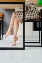 Barefoot female legs under the table