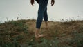 Barefoot girl climbing green hill close up. Young lady feet walking seacoast. Royalty Free Stock Photo