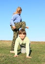 Barefoot girl stepping on boy Royalty Free Stock Photo