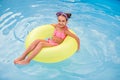 Barefoot girl swimming on ring in pool Royalty Free Stock Photo