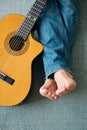 Barefoot Guitarist With Legs Outstretch Beside Guitar