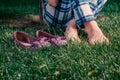 Barefoot harmony, girl sitting crosslegged on grass with her shes near