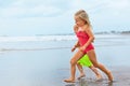 Barefoot kids run along sea beach Royalty Free Stock Photo