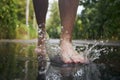 Barefoot leg of young man stepping to puddle Royalty Free Stock Photo