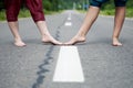 Barefoot legs of an adult woman and a young girl on the asphalt road Royalty Free Stock Photo